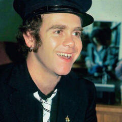 Younger Elton John with no glasses.